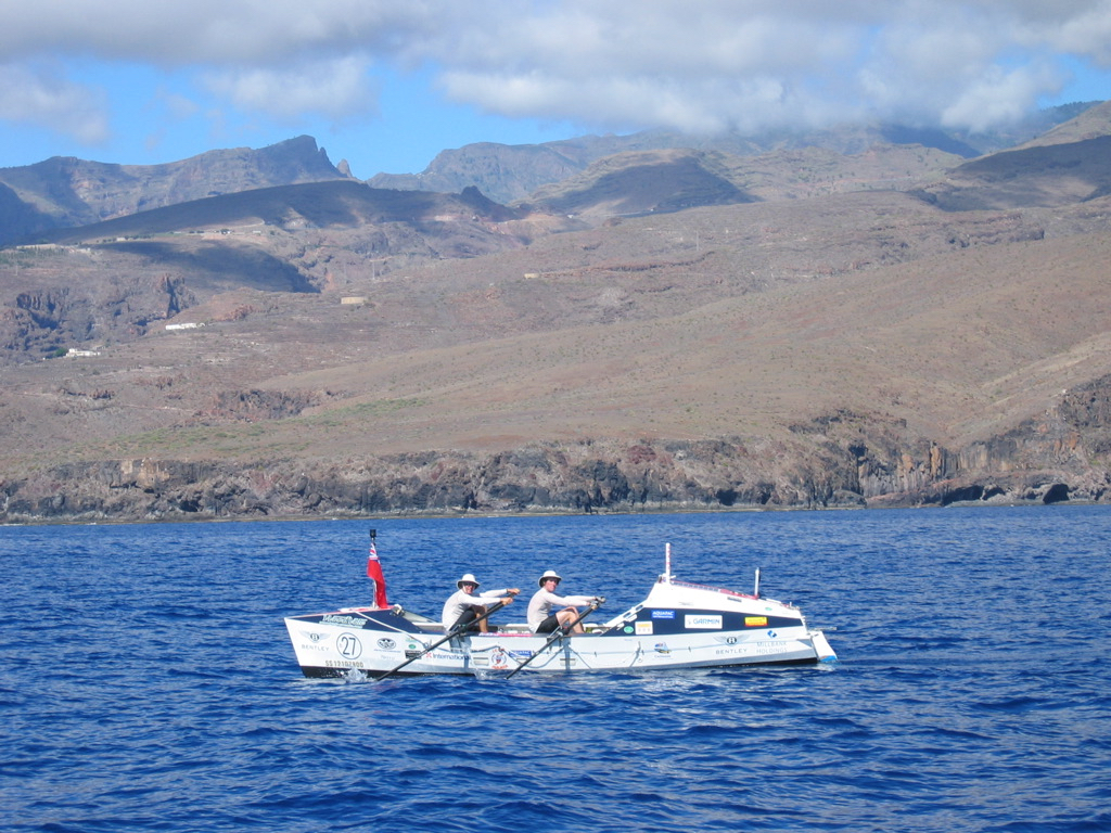 The rowing boat off a volcanic coastline during Phillip Carrington’s crossing